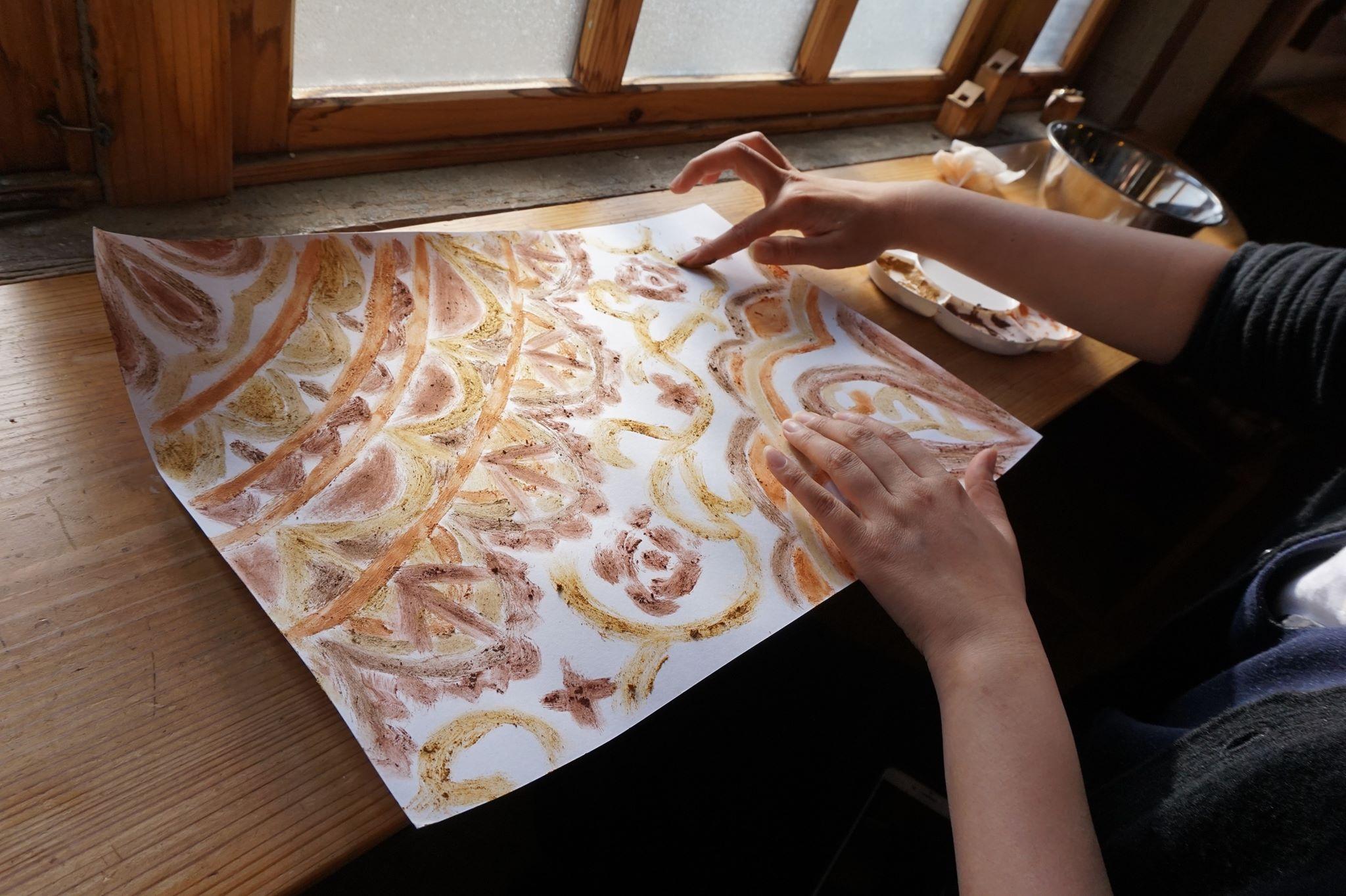 土で絵を描く